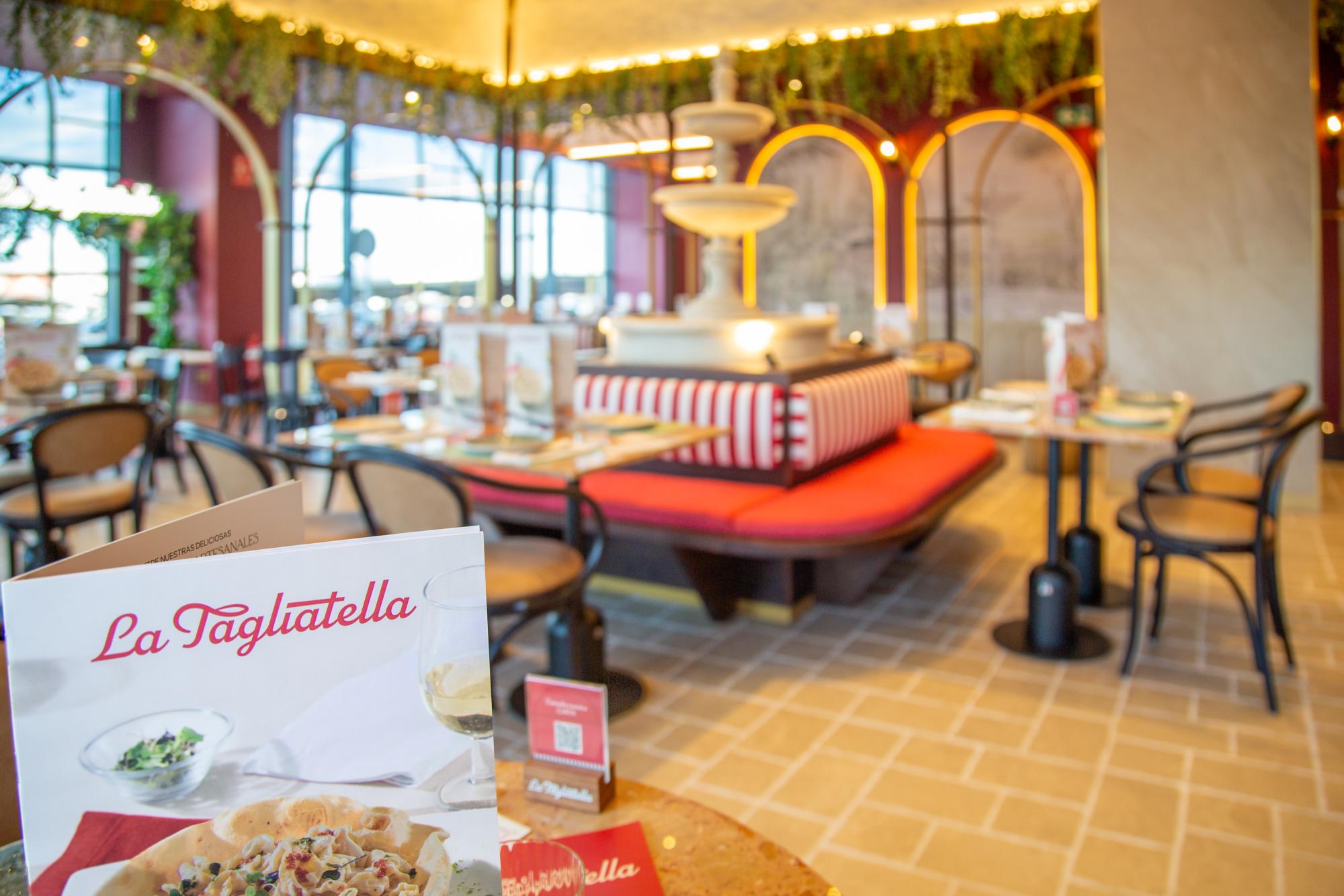 nterior of La Tagliatella restaurant with elegant decor, cozy seating, Italian-style fountain centerpiece, and a close-up of the menu featuring pasta and wine